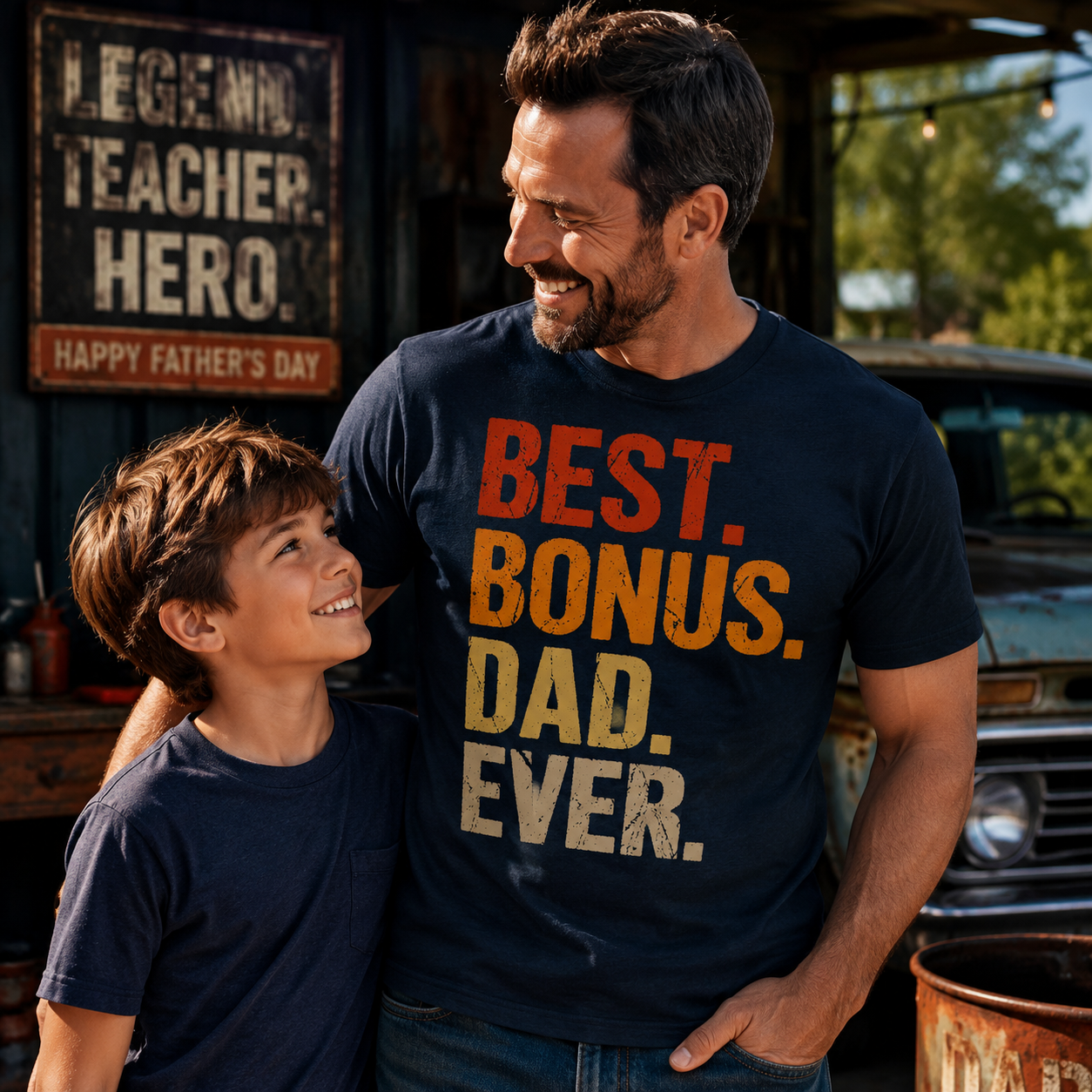 Man and child wearing matching t-shirts with a Father's Day message, standing outdoors.