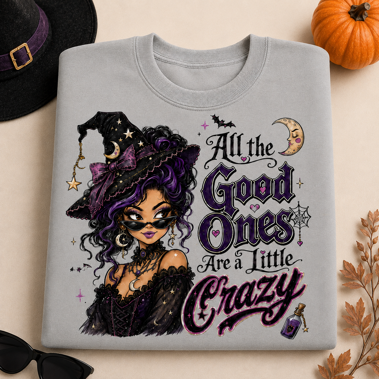 Cement Halloween witch sweatshirt featuring “All the Good Ones Are a Little Crazy” graphic with purple, pink and black witch design.
