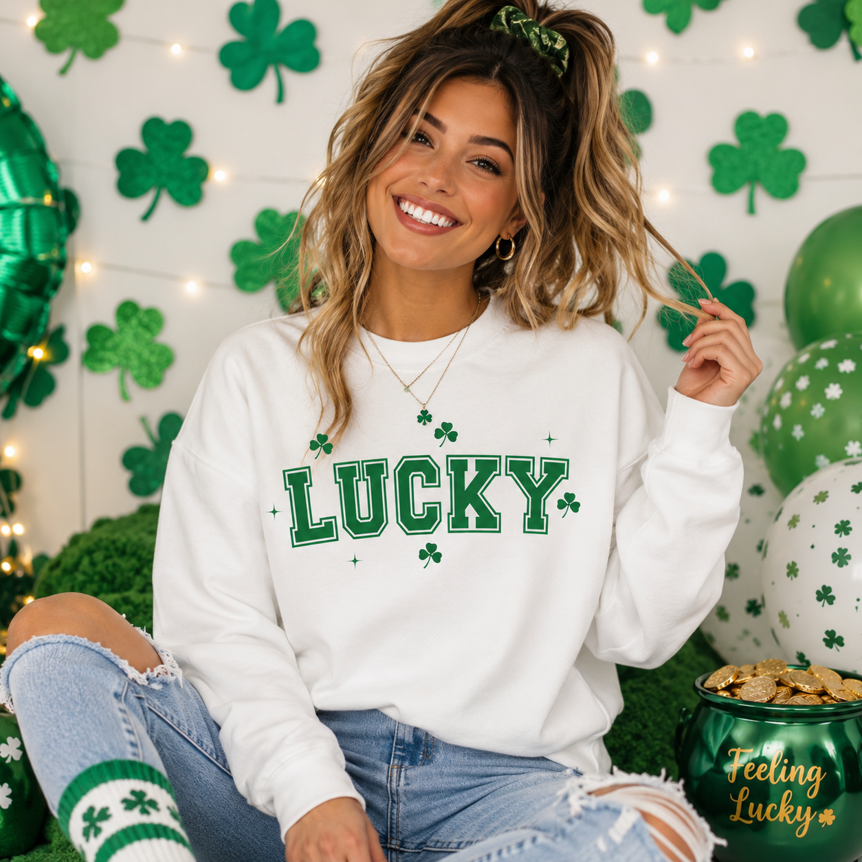 Woman wearing a white sweatshirt with 'LUCKY' in green text, sitting in front of a St. Patrick's Day-themed background.