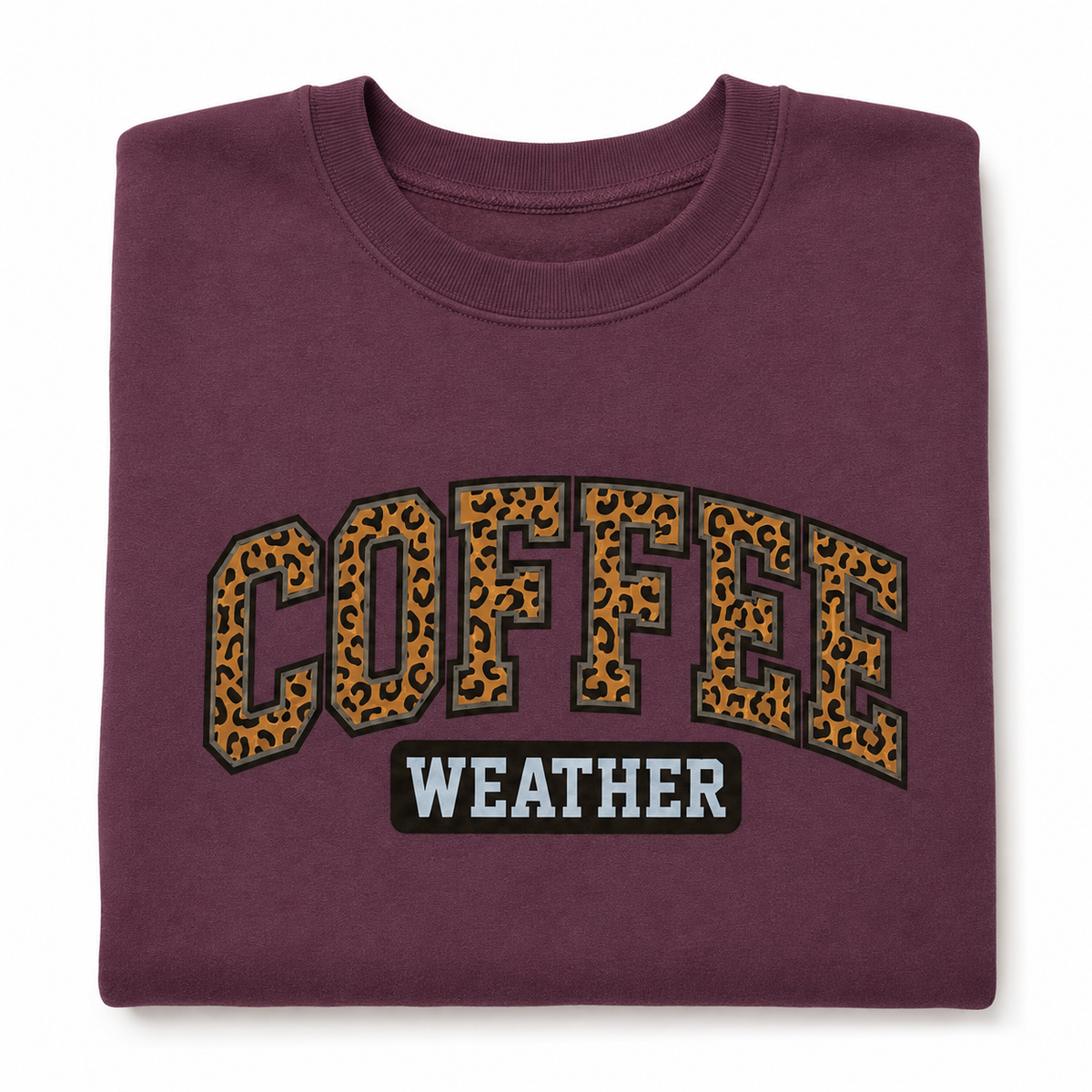 Folded Maroon Coffee Weather Sweatshirt with bold leopard print lettering on a white background