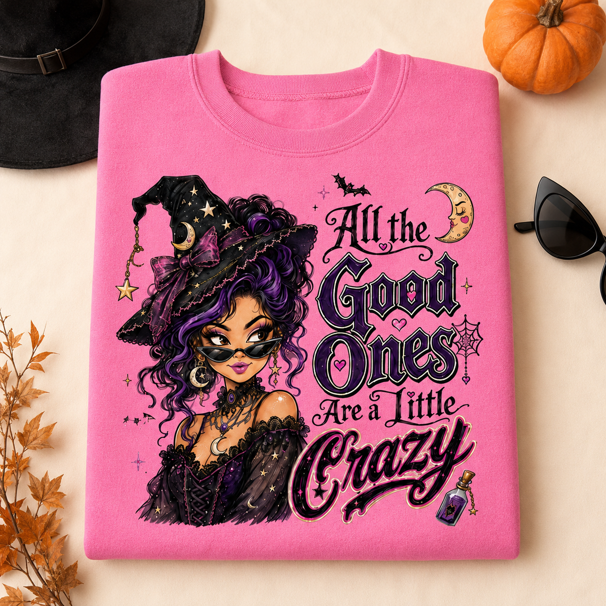 Pink Lemonade Halloween witch sweatshirt laid flat with “All the Good Ones Are a Little Crazy” graphic featuring a purple and black witch design.

