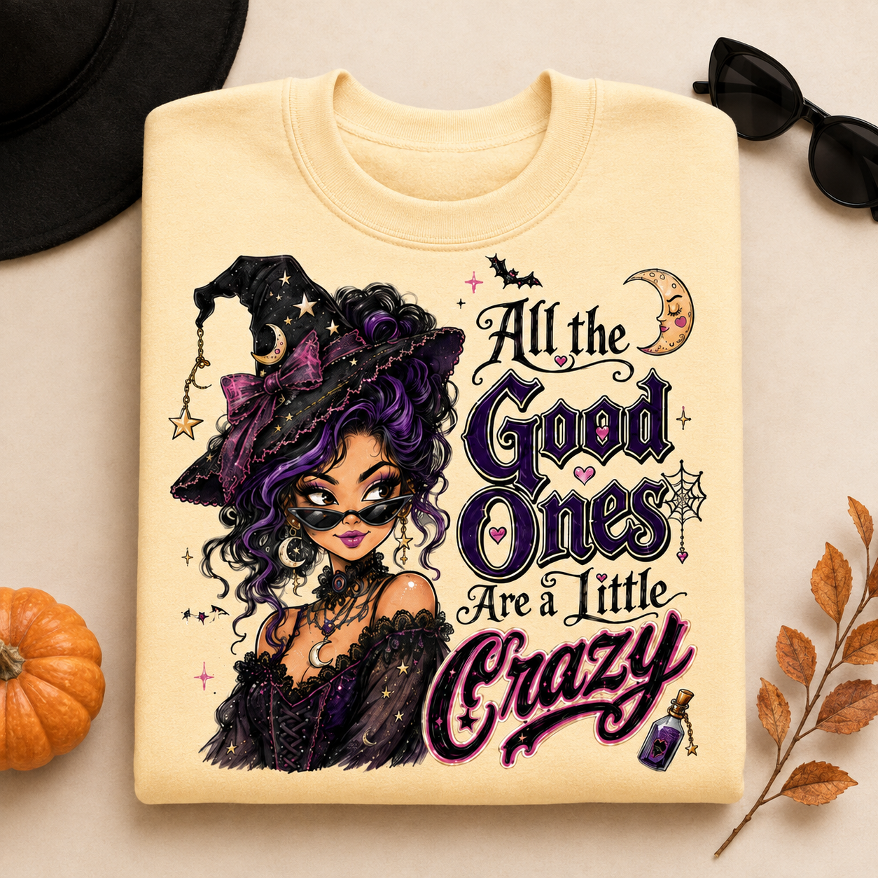 Yellow Haze Halloween witch sweatshirt laid flat with the “All the Good Ones Are a Little Crazy” graphic, featuring a purple-haired witch, moon, bats, stars, and potion details.
