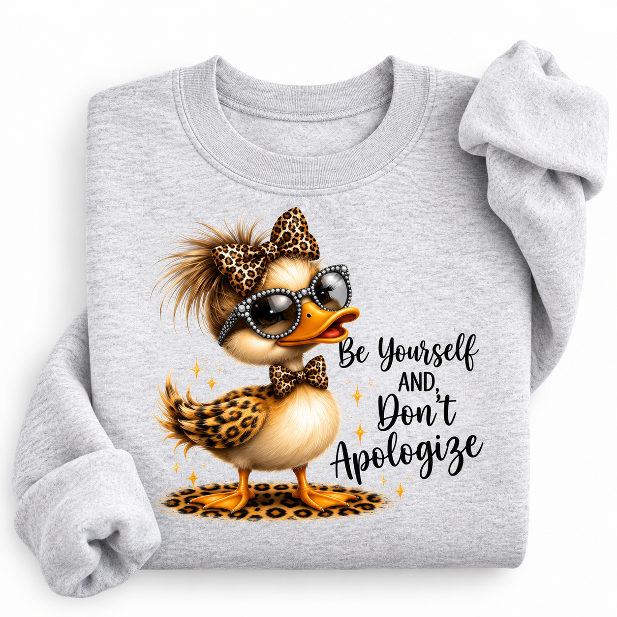 A light heather gray sweatshirt with a graphic of a stylish duck wearing leopard-print sunglasses, sunglasses, and a bow tie, next to the text 'Be Yourself AND Don't Apologize'.