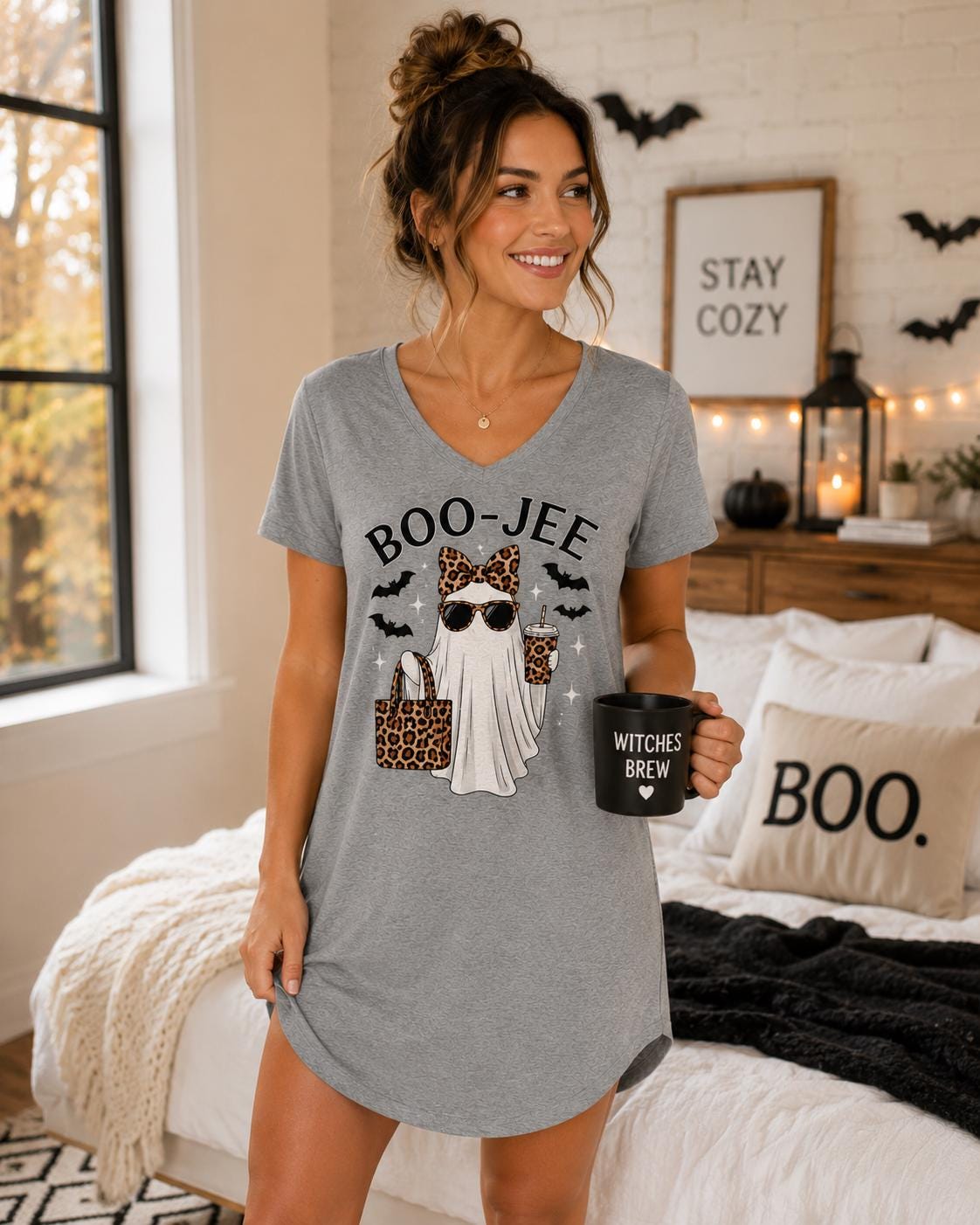 Gray BOO-JEE Ghost Halloween Sleep Shirt with leopard print ghost graphic modeled in a cozy Halloween bedroom setting