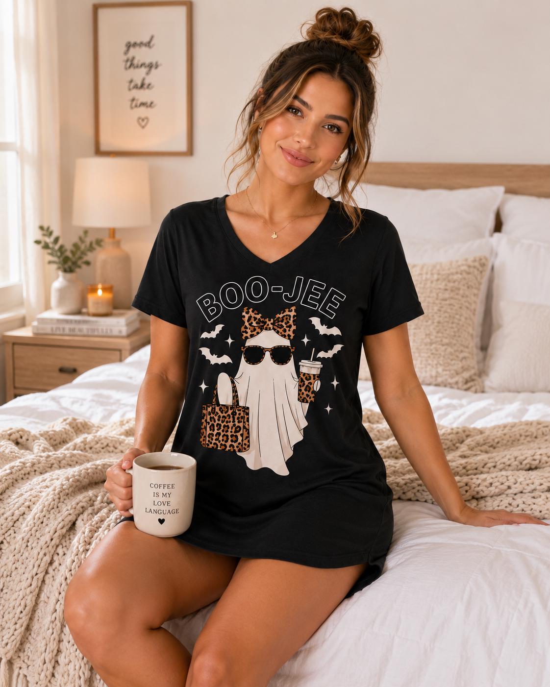 Black BOO-JEE Ghost Halloween Sleep Shirt with leopard print ghost graphic modeled in a cozy bedroom with a coffee mug