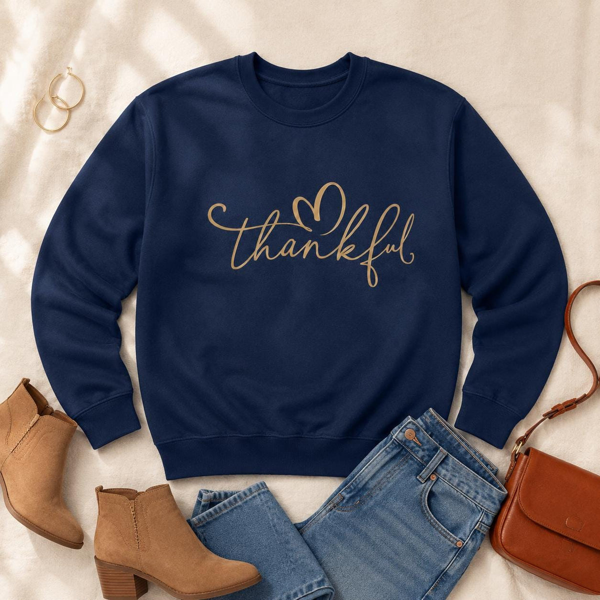 Navy Thankful Sweatshirt with gold script heart design styled with jeans and fall accessories