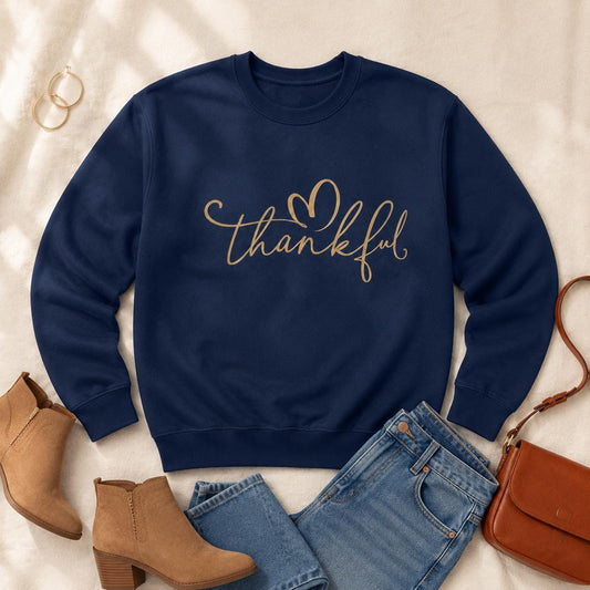 Navy Thankful Sweatshirt with gold script heart design styled with jeans and fall accessories