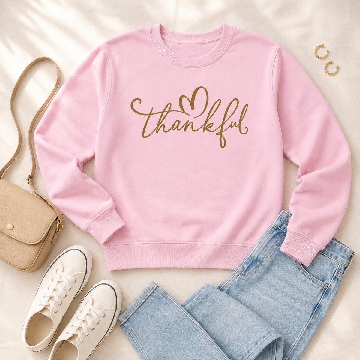 Pink Thankful Sweatshirt with gold script heart design styled with jeans and casual fall accessories
