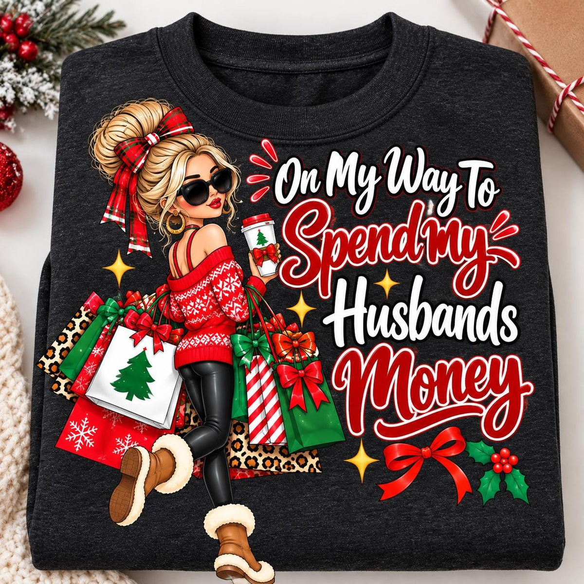 Folded heather black Christmas shopping sweatshirt with colorful holiday graphic.