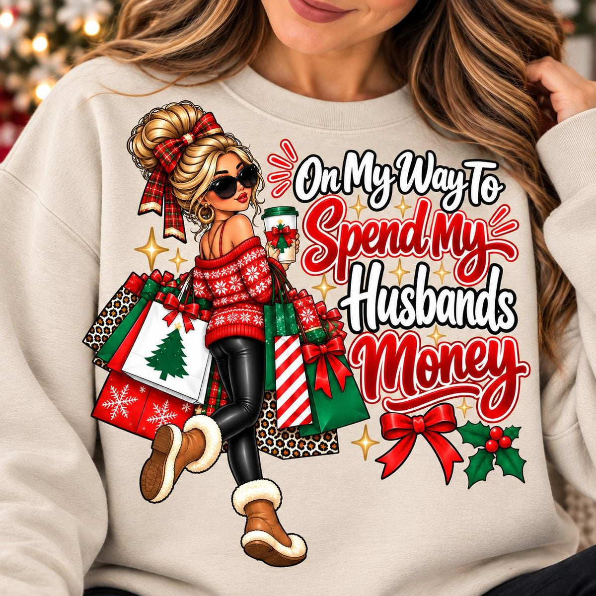 Woman wearing a sand holiday shopping sweatshirt with husband’s money quote.