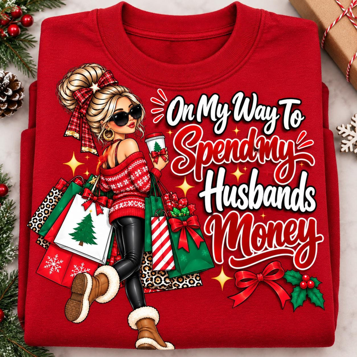 Folded red funny wife Christmas sweatshirt with holiday shopping graphic.