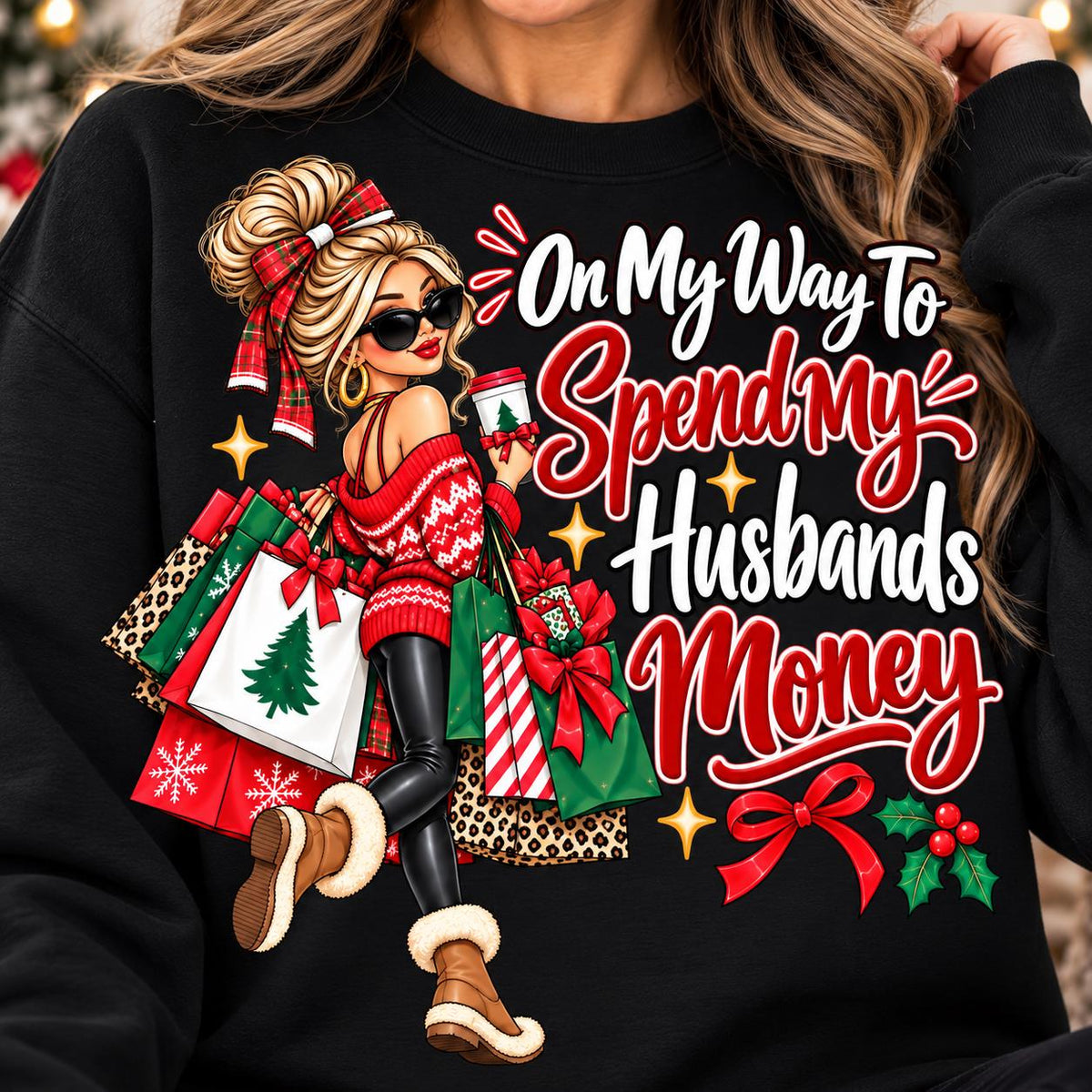 Woman wearing a black On My Way to Spend My Husband’s Money Christmas sweatshirt.