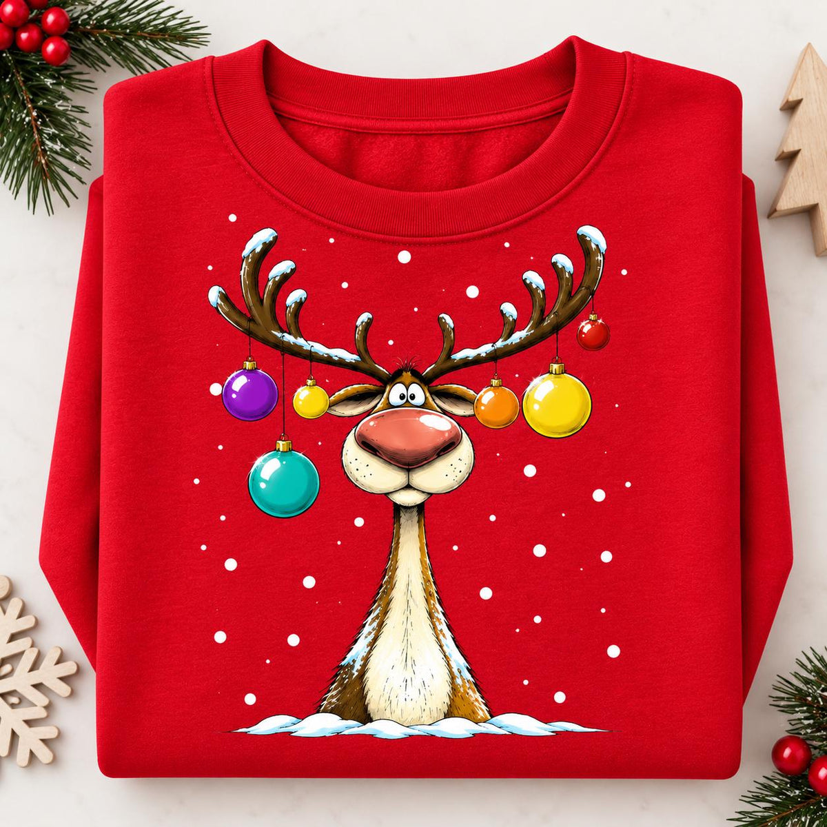 Folded Red Christmas sweatshirt featuring a goofy ornament reindeer.