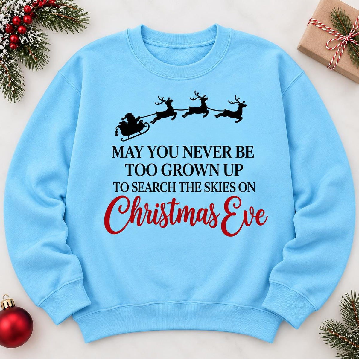 Sky blue Christmas Eve sweatshirt laid flat with nostalgic holiday message.