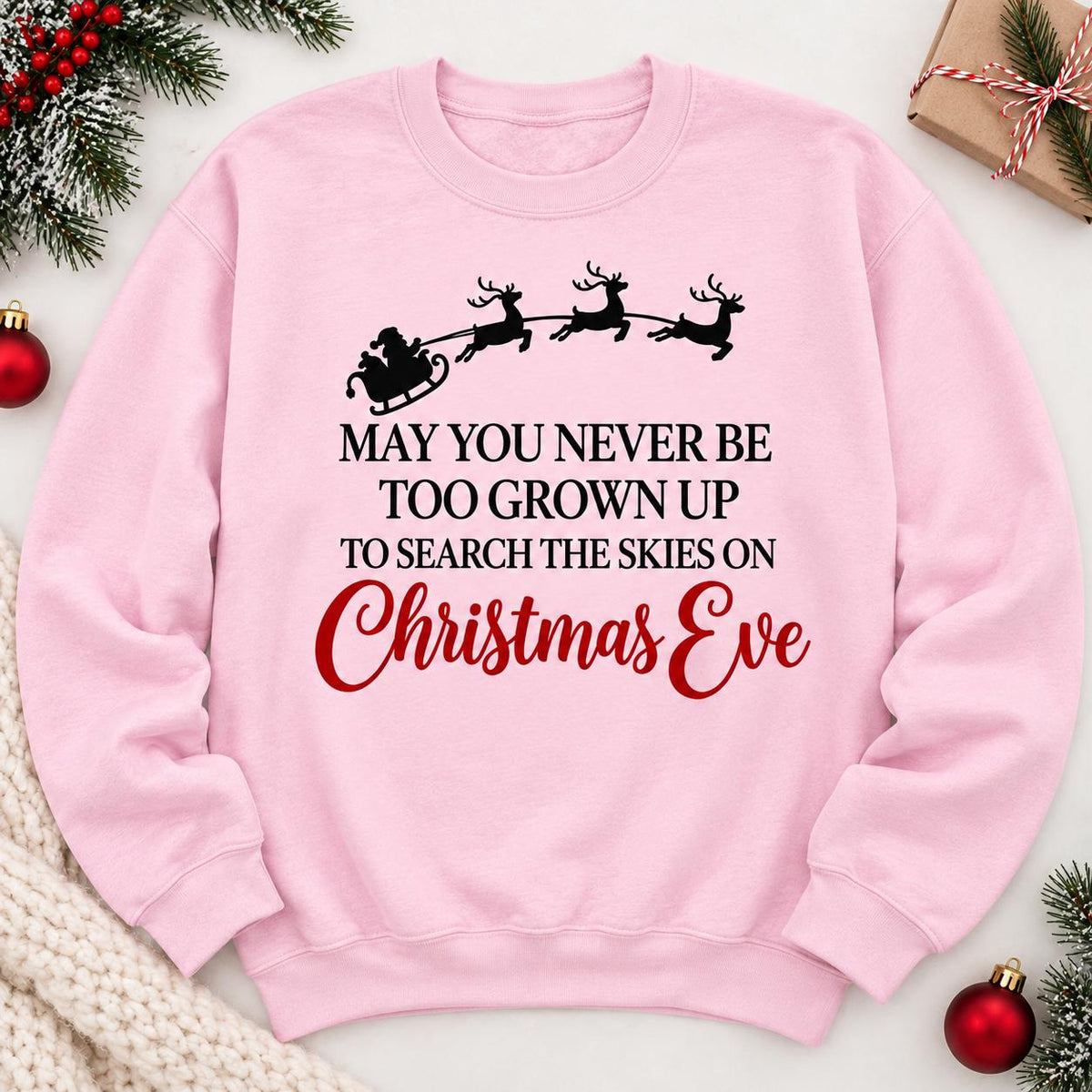 Light Pink Christmas Eve sweatshirt laid flat with Santa and reindeer design.