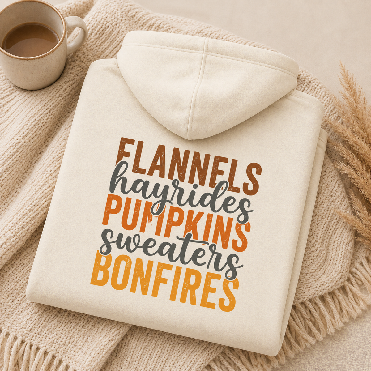 Folded Off White fall hoodie with Flannels, Hayrides, Pumpkins, Sweaters and Bonfires graphic printed on the back.