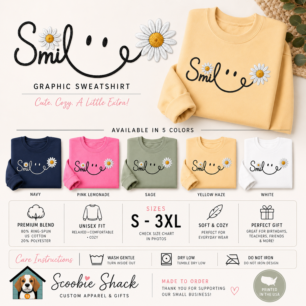 A promotional graphic for a custom graphic sweatshirt by Scoopie Shack, showing a pale yellow sweatshirt with a smiley face made from the word 'Smile' and small daisy graphics. The image includes text describing the design, available colors (navy, pink, sage, yellow haze, white), sizing, care instructions, and a branded logo.
