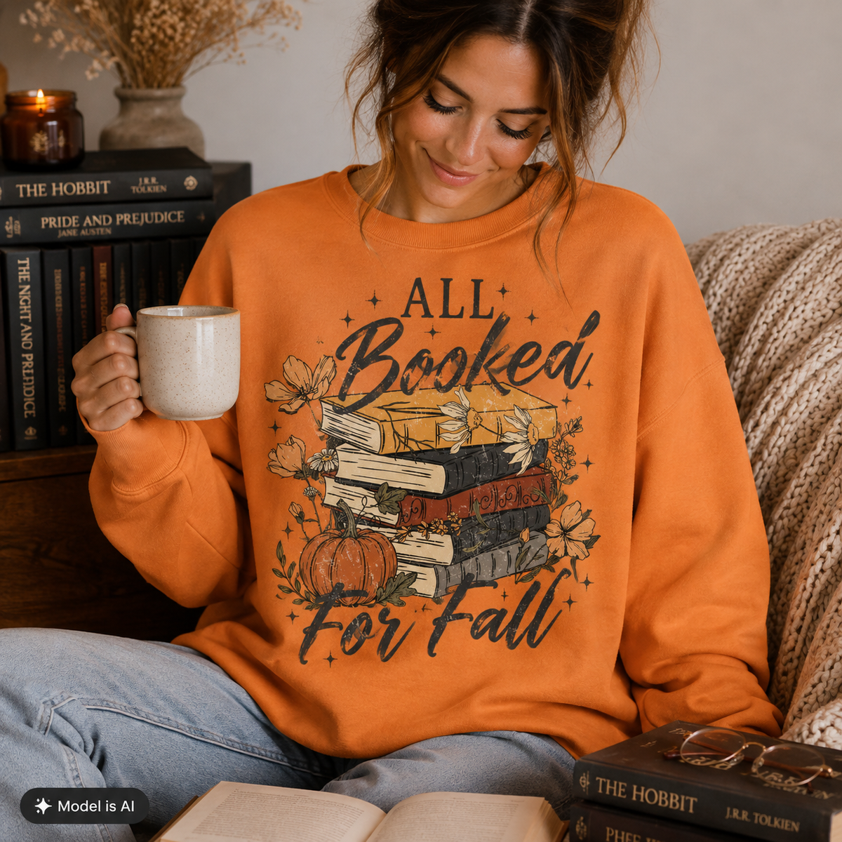 Woman wearing a Tangerine Fall Book Lover Sweatshirt with All Booked for Fall books and pumpkin graphic while holding a coffee mug.
