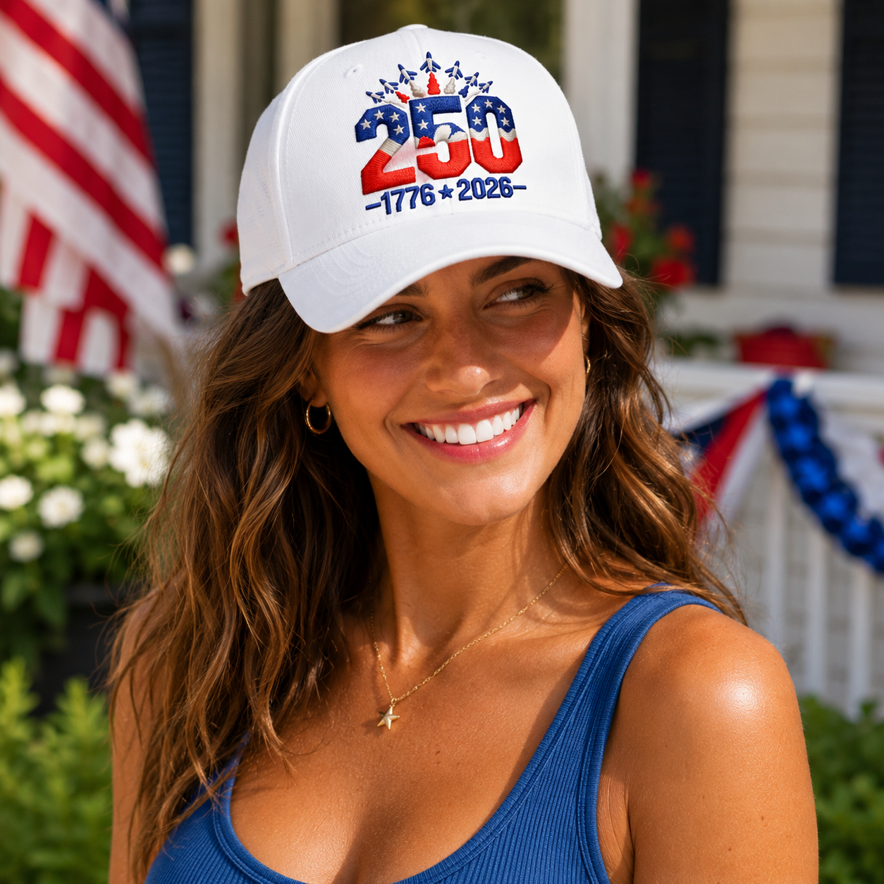 Woman wearing a white cap with 250th anniversary design in front of an American flag.