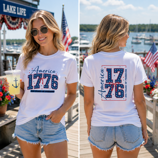 Woman wearing a 'America 1776' t-shirt by a waterfront with American flags. The Scoobie Shack
